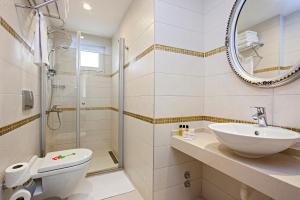 a bathroom with a sink and a toilet and a shower at The Room Hotel & Apartments in Antalya