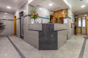 a lobby with a counter in a building at Residencial Horizonte in Lisbon