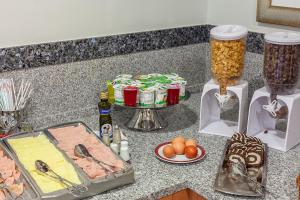 a kitchen counter filled with lots of food at Residencial Horizonte in Lisbon