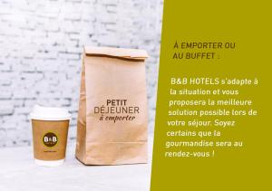 a paper cup of coffee and a paper bag at B&B HOTEL Lyon Sud États-Unis in Vénissieux