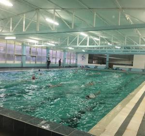 a group of people swimming in a swimming pool at La dolce vita, relax & kite Lamezia in Lamezia Terme