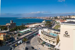 an aerial view of a city with the ocean at Vila Galé Estoril in Estoril