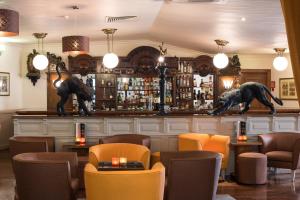 a bar with two statues of dogs on the counter at Vila Galé Estoril in Estoril