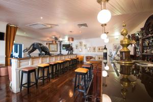 a bar with a dinosaur statue on the counter at Vila Galé Estoril in Estoril