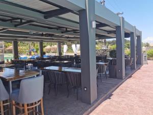 an outdoor dining area with tables and chairs and tablesktop at Sidari Waterpark in Sidari