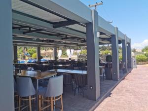 an outdoor dining area with tables and chairs and tablesktop at Sidari Waterpark in Sidari