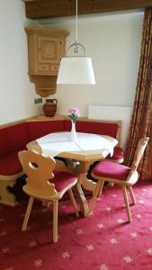 a dining room with a table and four chairs at Landhotel Böld Oberammergau in Oberammergau