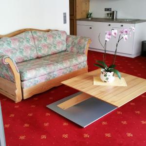 a living room with a couch and a coffee table at Landhotel Böld Oberammergau in Oberammergau