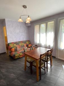 a living room with a table and a couch at Les Gîtes in Jausiers