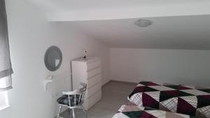 a bedroom with a bed and a mirror and a chair at Big Blue - Xenija (Veliko Plavetnilo - Ksenija) in Metajna