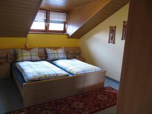 a small bedroom with a bed in a attic at Ferienwohnung Kreuzer Lydia in Furth im Wald