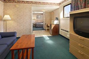 a living room with a couch and a television at Super 8 by Wyndham Atlantic City in Atlantic City