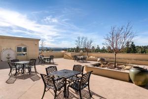 a patio with tables and chairs and a fountain at La Quinta by Wyndham Trinidad in Trinidad