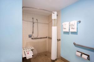 a bathroom with a toilet, sink, and shower stall at Days Inn by Wyndham Florida City in Florida City