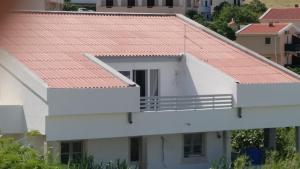 a white house with a red roof at Big Blue - Xenija (Veliko Plavetnilo - Ksenija) in Metajna