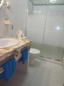 a bathroom with a sink and a toilet and a shower at Apartamentos Sirena in Mogán