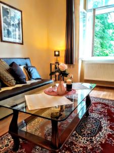 - un salon avec un canapé et une table en verre dans l'établissement Apartment Sense of Zizkov, à Prague