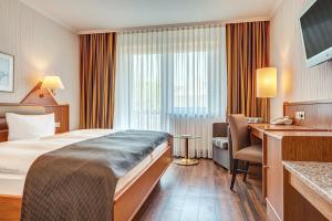 Postel nebo postele na pokoji v ubytování Komforthotel Kaiserhof