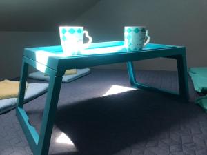 a blue table with two cups on top of it at Apartman Santorini in Novi Sad