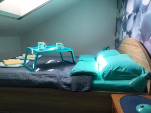 a room with a bed with a table on it at Apartman Santorini in Novi Sad