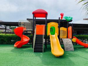 a playground with several different types of play equipment at Benwadee Resort Pattaya in Ban Pong