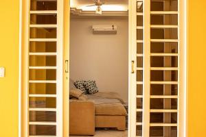 a living room with a door open to a room with a couch at Casa temporada in São João Batista do Glória