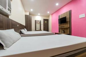 Postel nebo postele na pokoji v ubytování Hotel Vivek