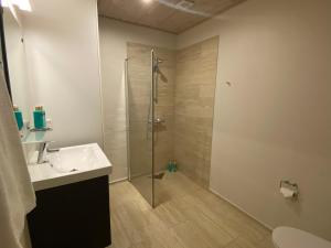 a bathroom with a shower and a sink at Hotel Sov Godt Herning in Herning