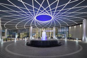 a large building with a fountain in front of it at Address Sky View in Dubai