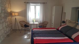 a bedroom with a bed and a table and chairs at Old Stone Holiday Home in Rovinj