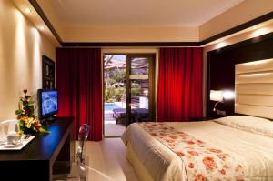 A bed or beds in a room at Oceanis Beach & Spa Resort