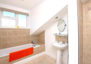a bathroom with a sink and a bath tub and a mirror at Goodwin Sands in Deal