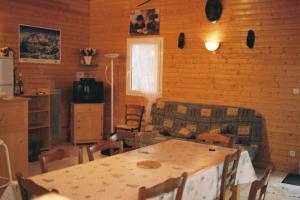 a living room with a table and a couch at chalet jennifer in Laveissière