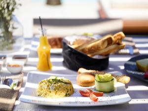 a table with a plate of food on it at Melidonia Suites in Akrotiri