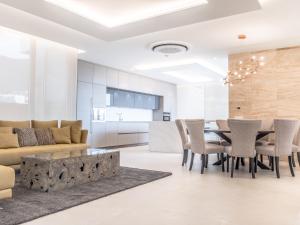 a dining room and living room with a table and chairs at CHALET 95, Lujo y Piscina Infinity in Adeje