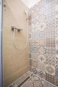 a shower with a shower head in a bathroom at Toplik in Sarajevo