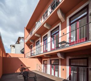 a balcony of a building with two chairs on it at Uma Formosa Apartments in Porto