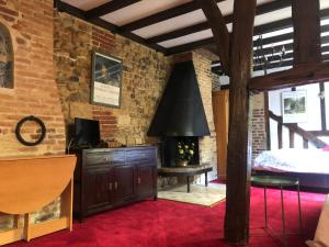 a room with a brick wall and a fireplace at Tim's secret place in Honfleur