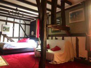 a bedroom with a bed and a pole at Tim's secret place in Honfleur