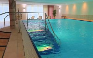 a swimming pool with a slide in a hotel room at Autenrieder Brauereigasthof in Ichenhausen