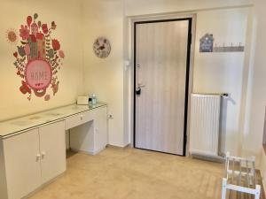 a room with a desk and a door with a sign on the wall at Cozy apartment near metro-Athens view in Athens +24 photos