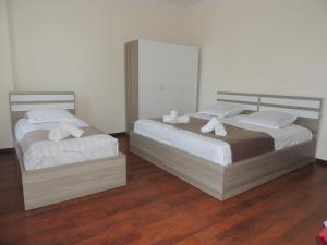 two beds sitting next to each other in a room at Apartment on St. Nikoloz Baratashvili 1 in Batumi