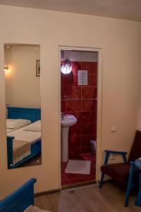 a bedroom with a bed and a bathroom with a shower at Pensiunea Sanziana in Gura Rîului