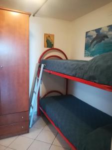 a bedroom with two bunk beds and a closet at Via Carru e Frau in Stintino