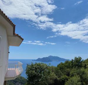 a balcony of a building with a view of the ocean at Acquamarina Accommodation in Massa Lubrense
