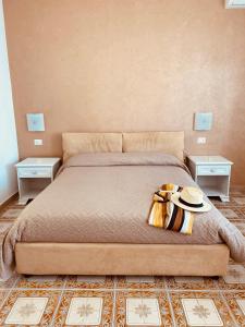 a bedroom with a large bed with two tables at Acquamarina Accommodation in Massa Lubrense