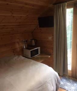 a bedroom with a white bed and a window at Lodge in Yeovil