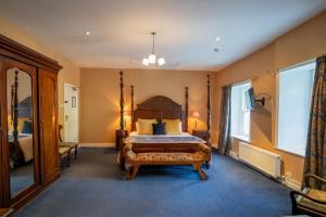 a bedroom with a bed and a large window at Innishannon House Hotel in Inishannon