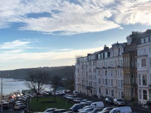 a parking lot with cars parked next to buildings at Harcourt Place in Scarborough