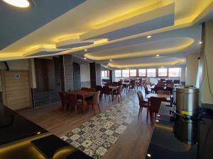 a dining room with tables and chairs in a restaurant at Palmiye Royale Palace in Edirne